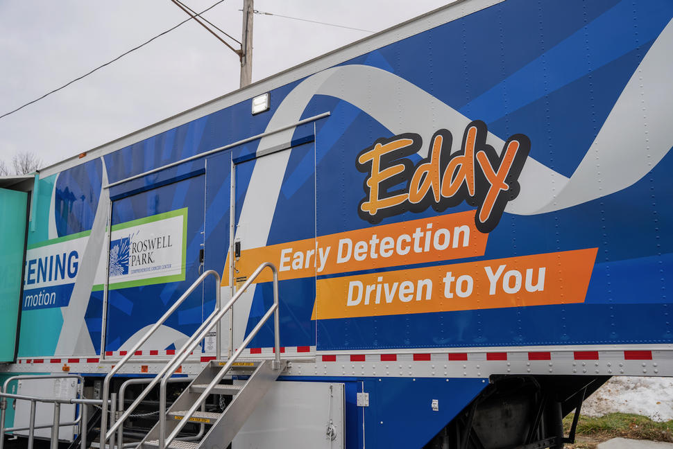 Photo of a blue trailer inscribed with the words "Eddy: Early Detection Driven to You"